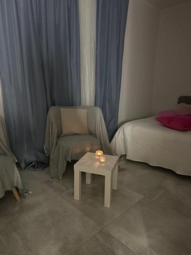 a living room with a bed and a table and a couch at Cozy V&S apartment with two bedrooms in Choszczówka