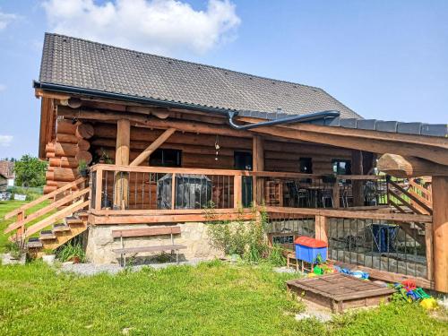 a log cabin with a porch and a deck at Chalet Srub Pohodář by Interhome in Benešov nad Černou