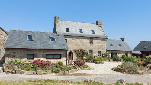 a large stone house with a driveway in front of it at Domaine de Kerzuat in Plouarzel