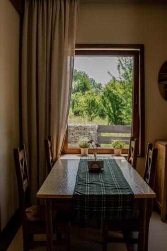 a dining room table with a view of a window at Perła Beskidu in Ustroń
