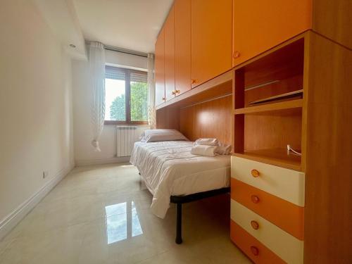 a bedroom with a bed and a large wooden cabinet at Comfort & design - 20' dalle terme di Saturnia in Manciano