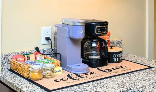 a coffee maker sitting on top of a counter with a box at Westcott Suite Apartments in Syracuse