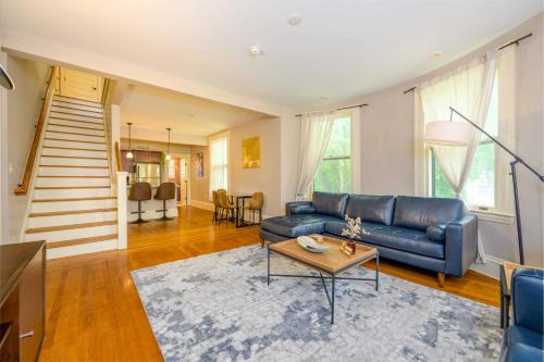 a living room with a blue couch and a table at Westcott Suite Apartments in Syracuse