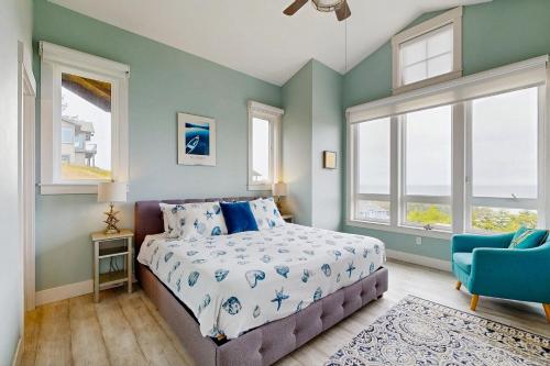 a bedroom with a bed and a chair and windows at Alta Vista in Pacific City