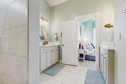 a bathroom with a sink and a mirror at Alta Vista in Pacific City