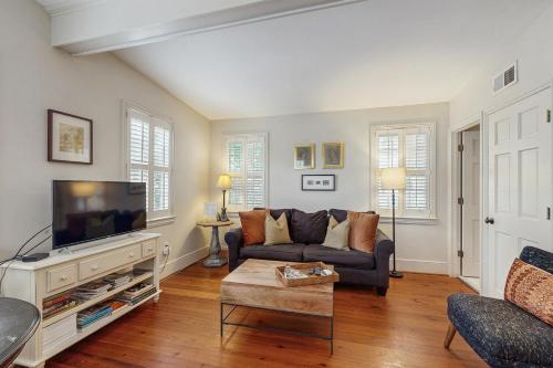 a living room with a couch and a tv at 4 Bee St in Charleston