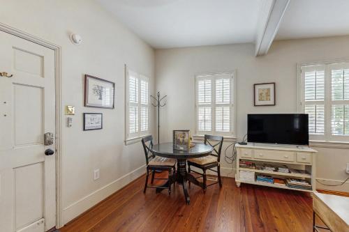 a dining room with a table and a tv at 4 Bee St in Charleston