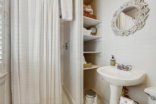 a bathroom with a shower curtain and a sink at 4 Bee St in Charleston