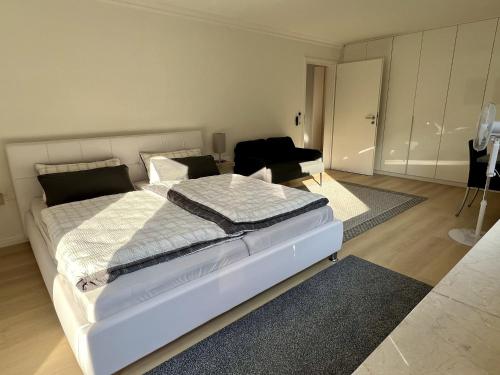 a bedroom with a bed and a living room at Ferienhaus Wasserburg in Wasserburg am Bodensee