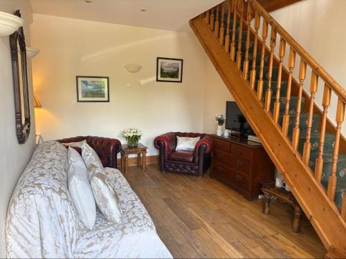 a bedroom with a bed and a staircase at Craig-Y-Nos Castle in Abercraf