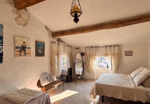 a bedroom with a bed and a window at Chez les artistes in Servian