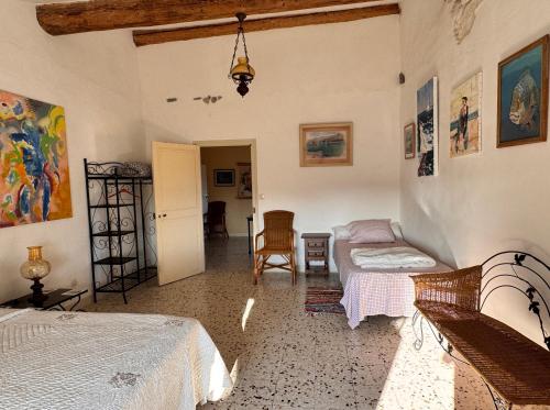 a bedroom with two beds and a table and a chair at Chez les artistes in Servian