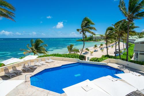 a view of the beach from a resort with a swimming pool at St. James's Club Resort - All Inclusive in English Harbour Town
