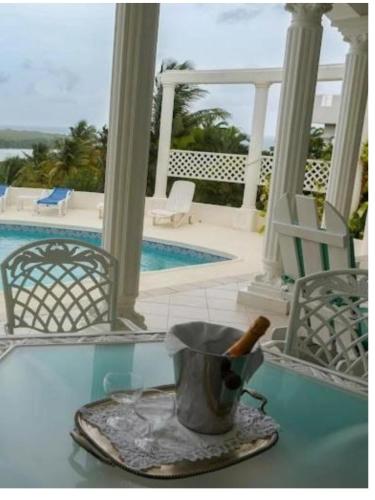 a table with a bucket with a knife on it at Castles In Paradise Villa Resort in Vieux Fort