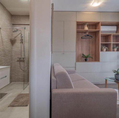 a living room with a couch and a shower at Boljevic Apartments in Bečići