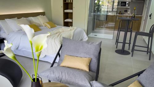 a bedroom with a bed and two chairs and a couch at Panorama Suites in Jorquera