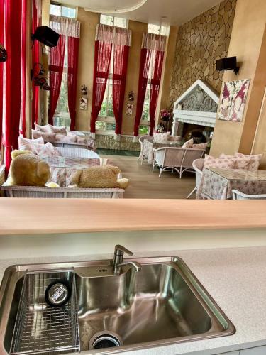 a kitchen with a sink and a living room at Socat Home in Luodong
