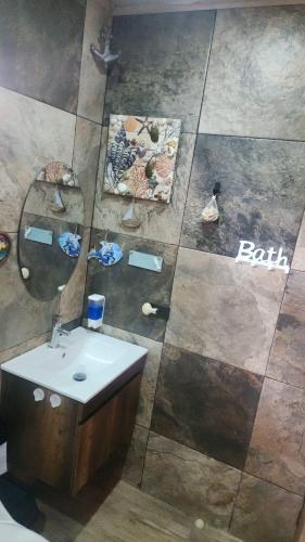 a bathroom with a sink and a mirror at Ecohacienda Perla Marina in Sardinal
