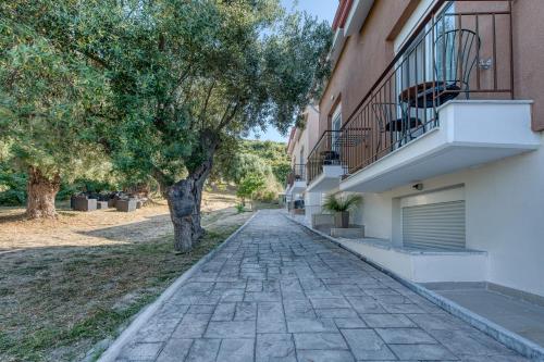 a cobblestone street in front of a building at Valery Apartments in Pefkohori