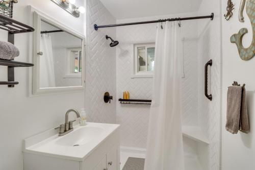 a white bathroom with a sink and a shower at Dog-Friendly Albuquerque Home 1 Mi to U of NM! in Albuquerque