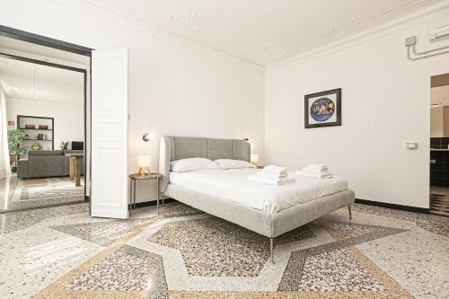 a white bedroom with a bed and a living room at iFlat Historical Luxury Apartment San Luca 11 A in Genova
