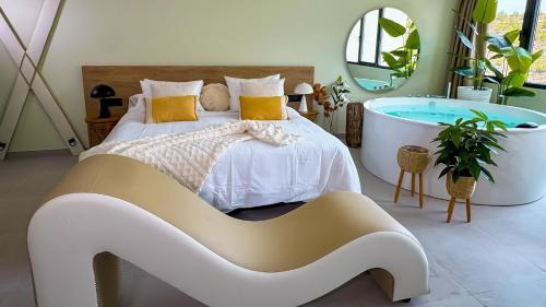 a bedroom with a bed and a bath tub at Panorama Suites in Jorquera