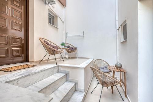 a pair of chairs and a table on a porch at Valery Apartments in Pefkohori