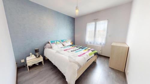 a small bedroom with a bed and a window at Palm Cornue avec piscine privative in Saint-Gilles-Croix-de-Vie