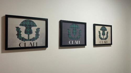 three framed pictures hanging on a wall at The Den - by Caithness Luxury Apartments NC500 - 2 Bedroom holiday home - Sleeps Work teams upto 2 & holiday makers upto 4 in Wick