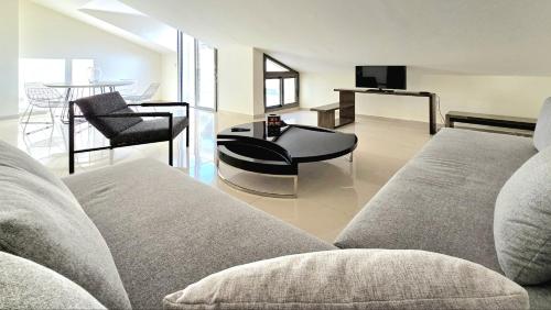 a living room with a couch and a table at Tabarja Hills apartment in ‘Ayn aş Şughayrah