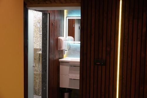 a bathroom with a sink and a mirror at Apartments Guinness in Sarajevo