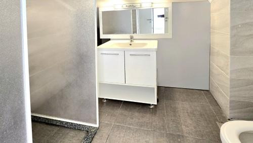 a bathroom with a sink and a mirror at Tabarja Hills apartment in ‘Ayn aş Şughayrah