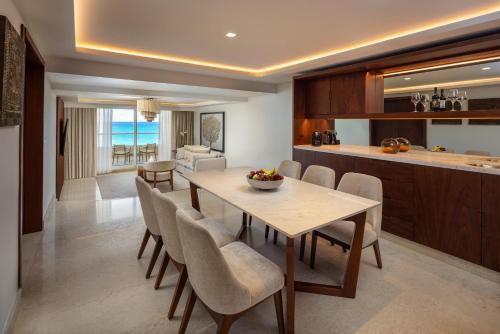 a kitchen and dining room with a table and chairs at Sun Palace - All Inclusive Adults Only in Cancún