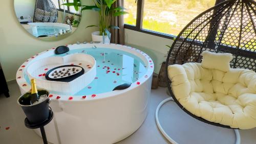 a bath tub with a swing and a chair at Panorama Suites in Jorquera