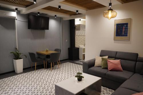a living room with a couch and a table at Apartments Guinness in Sarajevo
