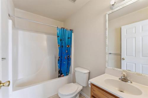 a bathroom with a toilet and a sink and a mirror at 3305 Park Blvd, Unit 3 in Wildwood
