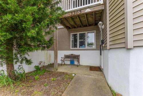 a house with a bench sitting under a window at 3305 Park Blvd, Unit 3 in Wildwood