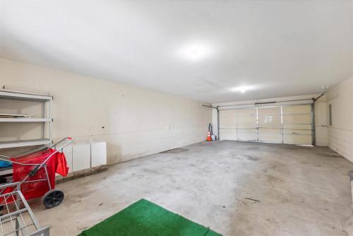 an empty garage with two garage doors and a red cart at 3305 Park Blvd, Unit 3 in Wildwood