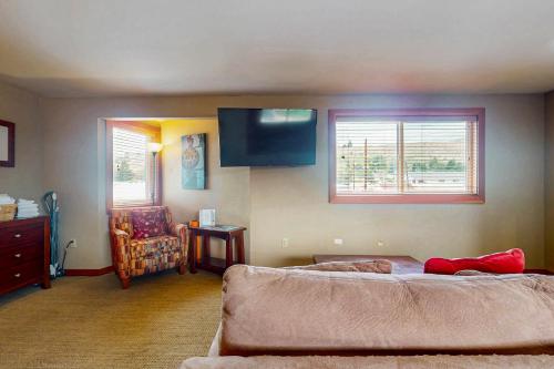 a living room with a couch and a flat screen tv at Cabana #11 in Chelan