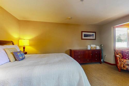 a bedroom with a bed and a dresser and a window at Cabana #11 in Chelan