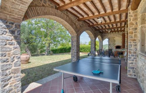a ping pong table on a patio with an arcade at Podere Anteata in Montegiovi