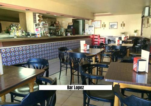 a restaurant with tables and chairs and a bar at Ruralux Aroche in Aroche