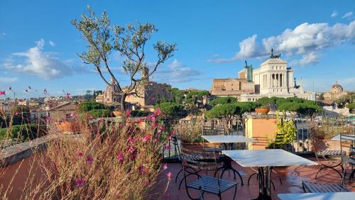 a view of a city from a patio with tables and chairs at Residenza Maritti Decò Style- Guesthouse in Rome