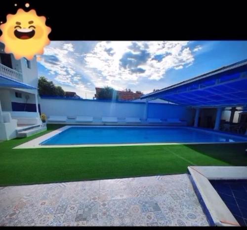 a large swimming pool in front of a house at Casa Paradise in Carmen de Apicalá