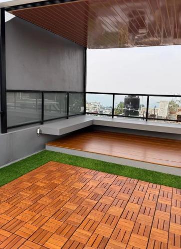 a room with a wooden floor and a large window at Villa Srikandi Caldera D5 in Tlekung