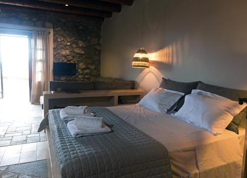 a bedroom with a bed with towels on it at Olivia Country House in Panayía