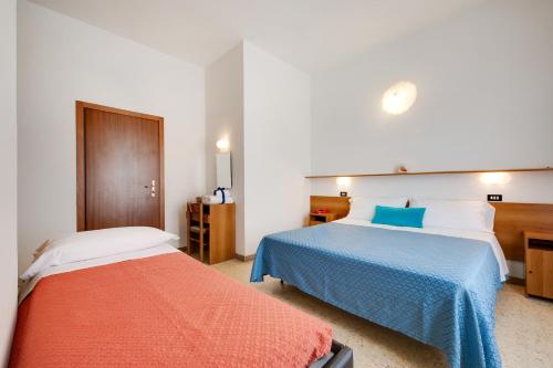 Postel nebo postele na pokoji v ubytování Hotel Numi