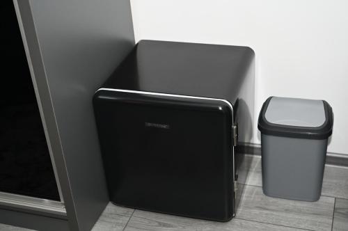a black trash can next to a trashcan next to a trashcan at Luxury Home in Cîmpulung