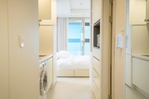a kitchen with a washer and dryer in a room at EL Stay Hotel Residence in Busan