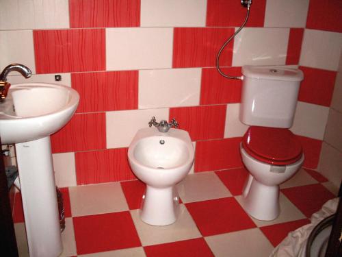 a bathroom with a toilet and a bidet and a sink at villa Magnolia in Donji Štoj